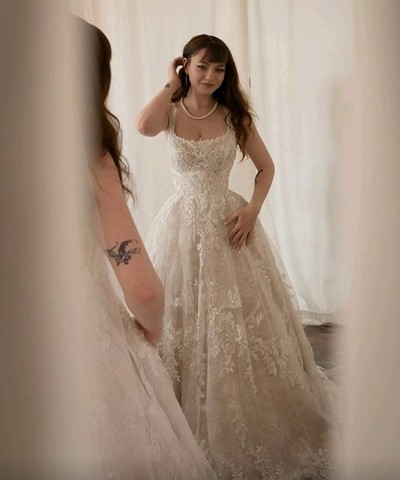 Candid portrait of the bride framed by a curtain