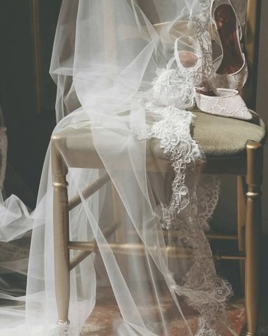 Veil and shoes draped over a gold chair