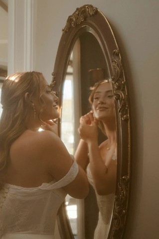 Bride reflected in an ornate gold mirror