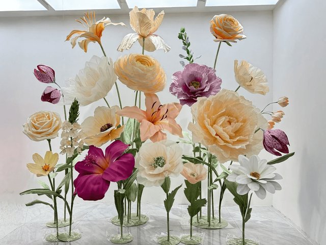 Oversized paper flowers in peach, cream and purple