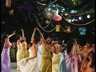 Guests dancing under hanging lanterns and a disco ball